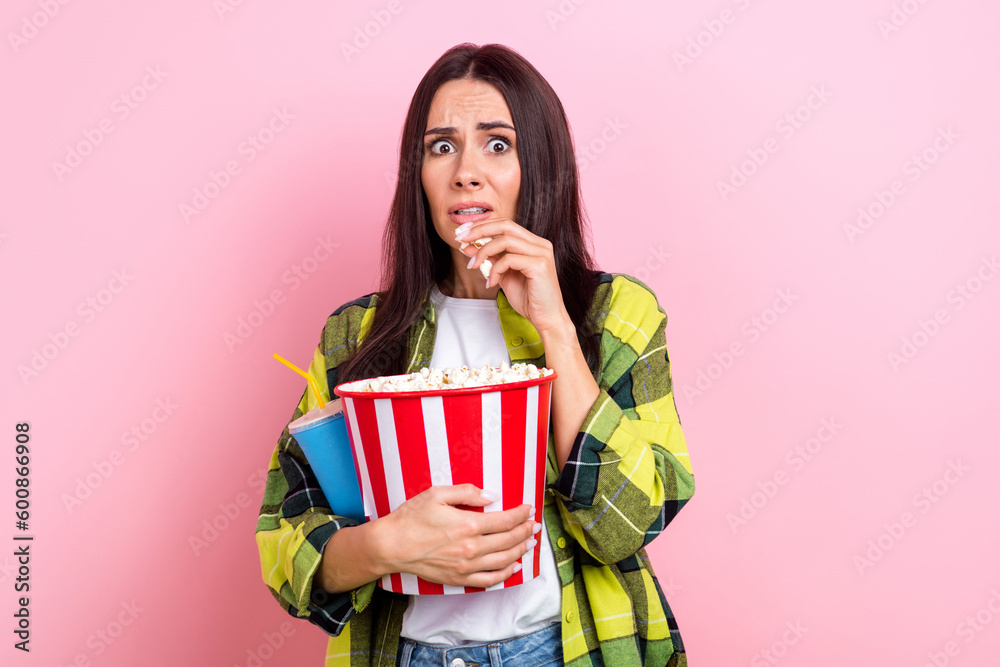 Portrait of terrified adorable woman brunette hair yellow jacket hold popcorn soda drink watch horror isolated on pink color background Portrait of terrified adorable woman brunette hair yellow jacket hold popcorn soda drink watch horror isolated on pink color background