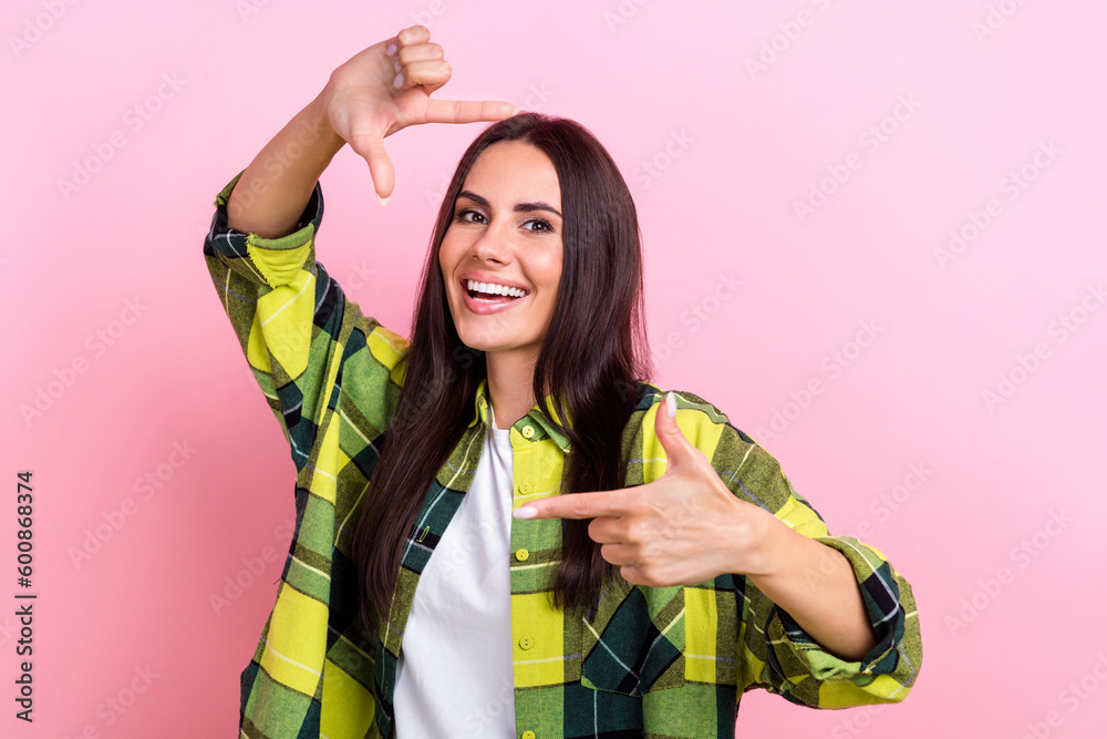 Photo of gorgeous lovely lady beaming smile arms fingers demonstrate cadre symbol isolated on pink color background Photo of gorgeous lovely lady beaming smile arms fingers demonstrate cadre symbol isolated on pink color background