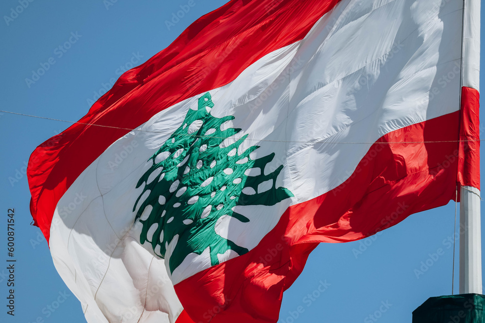 Fototapeta premium The Lebanese flag in the center of Beirut fluttering in the wind, close-up.