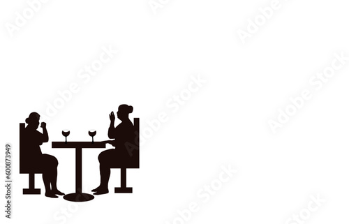 The drawing of silhouettes of two women sitting opposite each other at a table