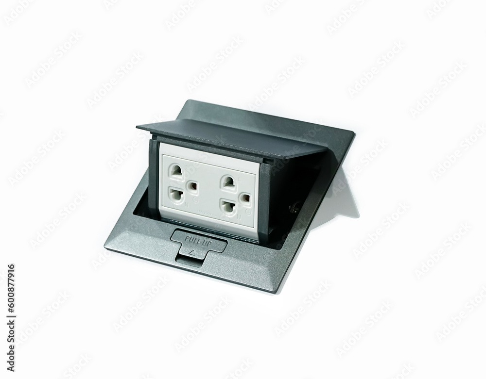 The power plug on the cement floor.Electrical equipment on the floor. Pop up electrical floor socket cover for plug on white background. The power plug on the cement floor.Electrical equipment on the floor. Pop up electrical floor socket cover for plug on white background.
