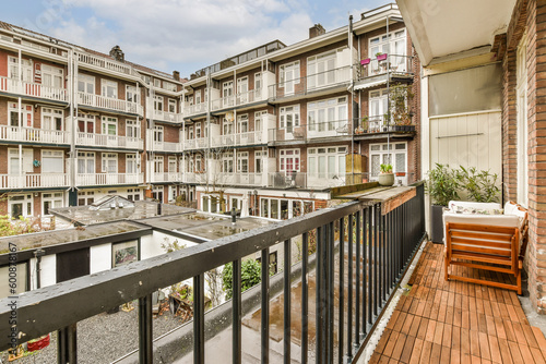 a balcony with some buildings in the background and an empty bench on the right hand side of the balcony area © Casa imágenes