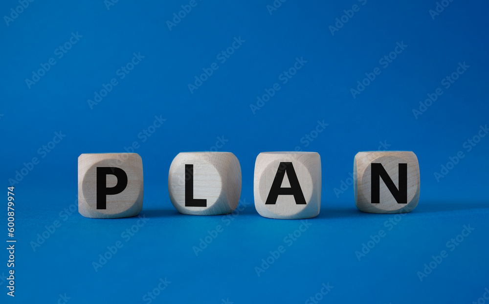 Plan symbol. Concept word Plan on wooden cubes. Beautiful blue background. Business and Plan concept. Copy space. Plan symbol. Concept word Plan on wooden cubes. Beautiful blue background. Business and Plan concept. Copy space.