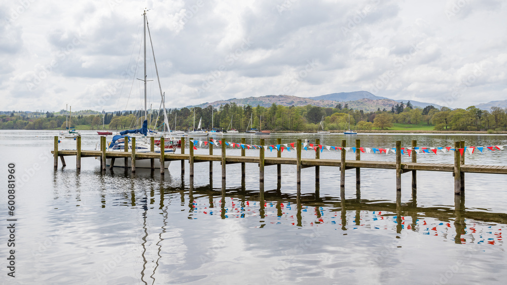 Red and white bunting reflects in Lake Windermere