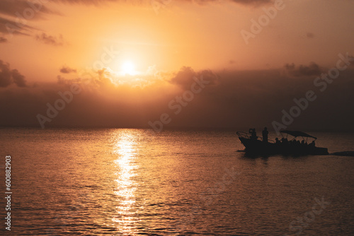 orange sunset in the sea with a tourism boat © juanjo328
