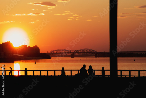 Silhouette of a couple in love against the background of a sunset