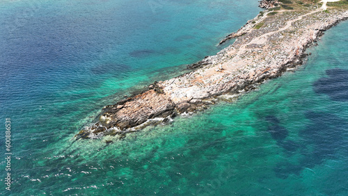 Aerial drone photo of rocky tropical exotic paradise island bay with deep turquoise sea forming a blue lagoon