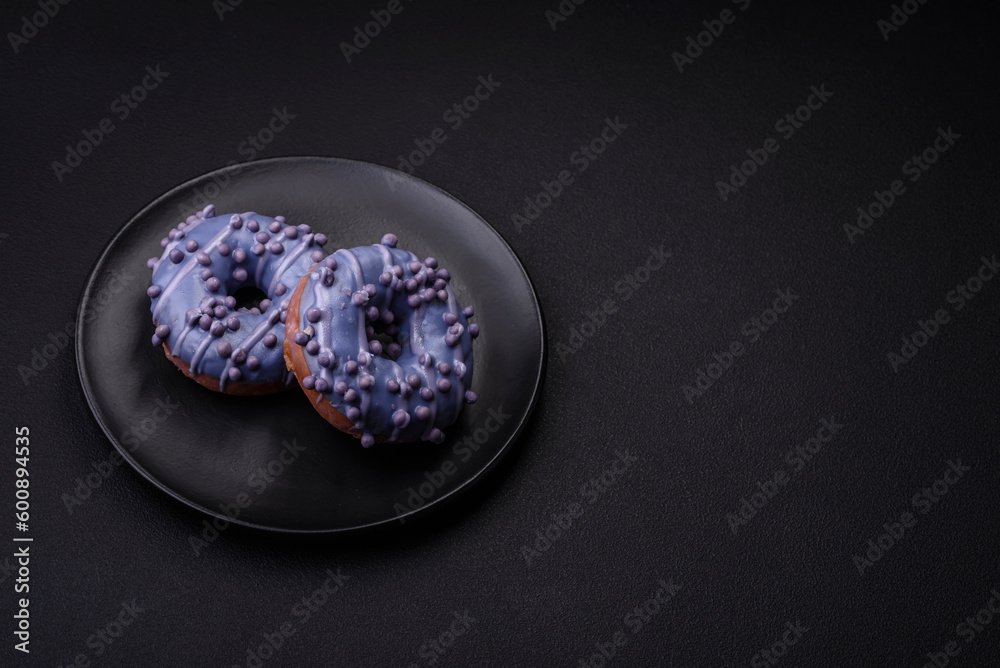 Delicious sweet donut of purple color in glaze and with lilac balls Delicious sweet donut of purple color in glaze and with lilac balls