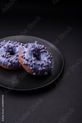 Fototapeta Naklejka Na Ścianę i Meble -  Delicious sweet donut of purple color in glaze and with lilac balls