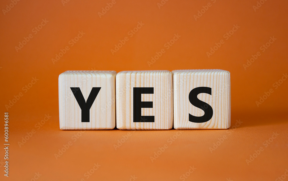 Yes symbol. Wooden blocks with word yes. Beautiful orange background. Business and yes concept. Copy space.