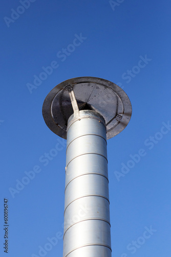 Metal chimney pipe on the roof of house