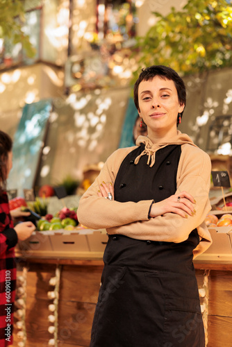 Tableau sur toile Portrait of woman farmer selling healthy food at local marketplace, showing seasonal fresh fruits and veggies at farmers market
