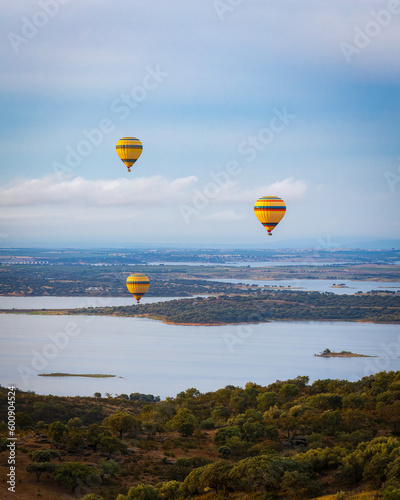 Hot air balloons over the river landscape at sunrise in Monsaraz, Alentejo, Portugal 
