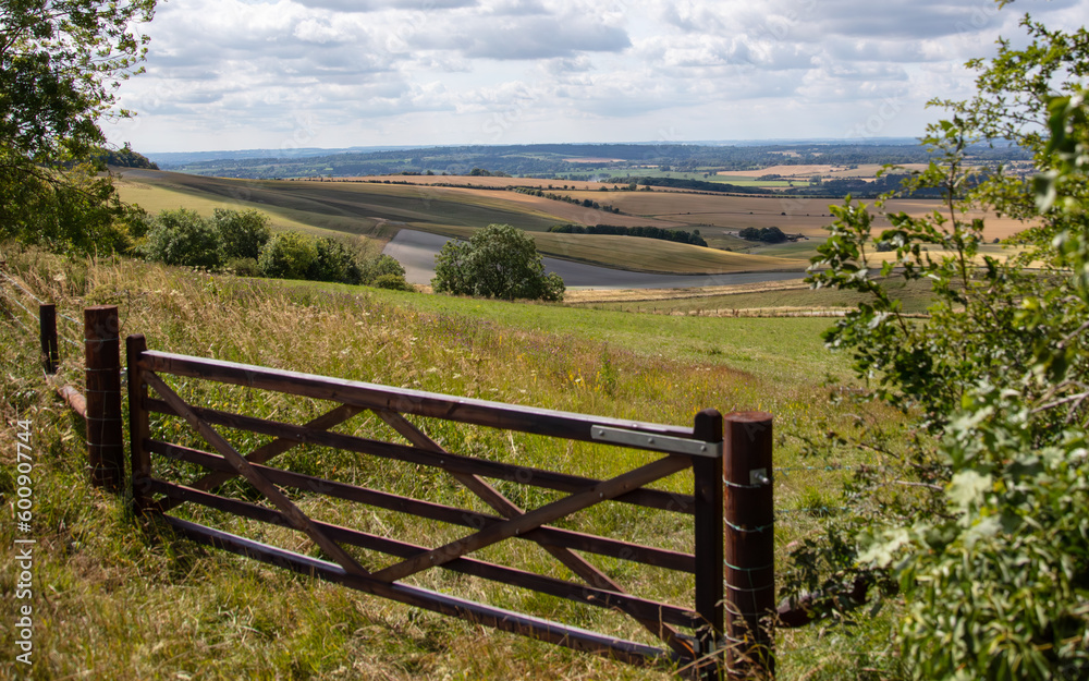wiltshire landscape with cloud, sky and a five bar gate.