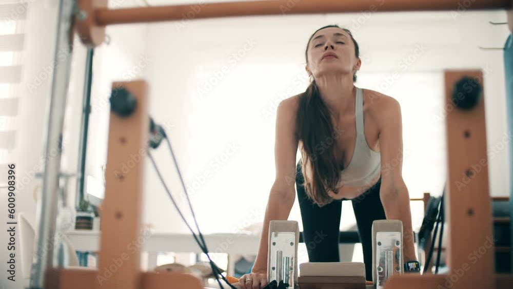 Woman breathes deeply while making her sports exercises Woman breathes deeply while making her sports exercises