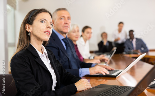 Attentive businesswoman listening to a speaker at a business meeting