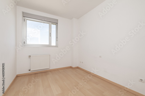 An empty room in an apartment with an aluminum and glass window