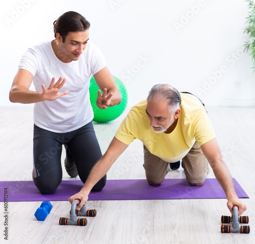 Old man doing exercises indoors