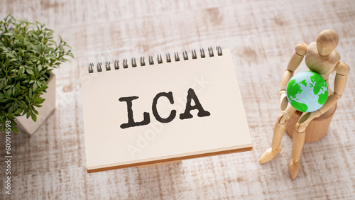 There is notebook with the word LCA. It is an abbreviation for Life Cycle Assessment as eye-catching image. photo