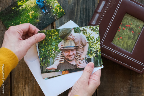 Photo printing, family memories. Woman looks at printed photos for family picture album.