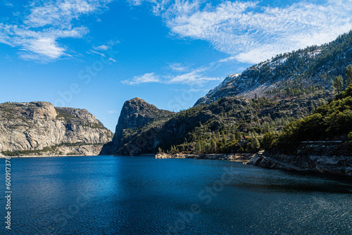 Yosemite National Park, CA, USA - March 7, 2022: Hetch Hetchy Lake, dam, waterfalls, peaks and rock formations.
