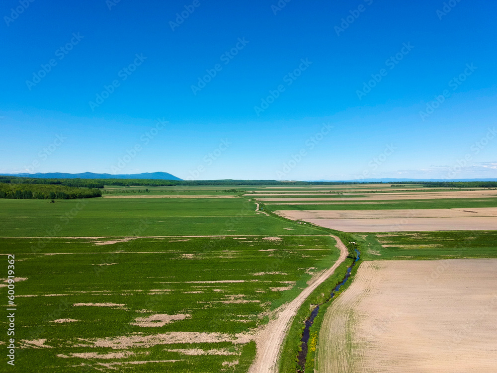 Aerial view of a road passing through the countryside on a beautiful summer day
