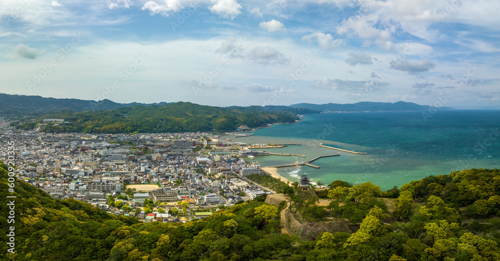 Panoramic aerial view of Sumoto Castle and small town in coastal landscape