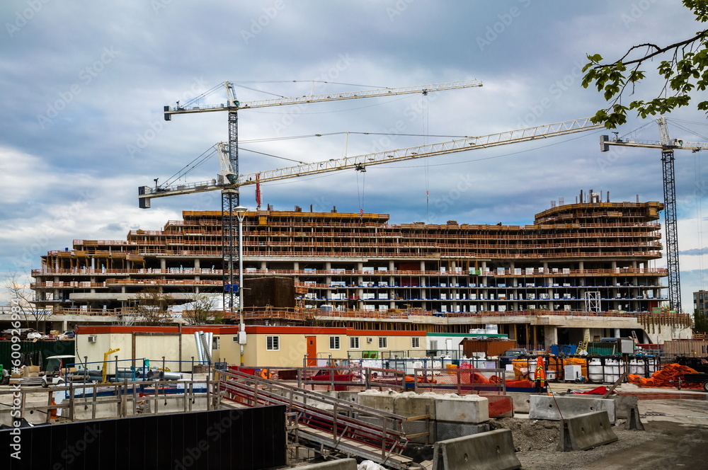 Large construction site with construction cranes working on a building ...