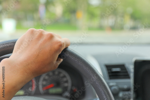 hand on driving wheel symbolizes control, direction, and responsibility. It represents the power and freedom of mobility, as well as the need to be focused, alert, and responsible while driving