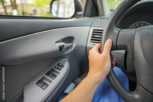 hand on driving wheel symbolizes control, direction, and responsibility. It represents the power and freedom of mobility, as well as the need to be focused, alert, and responsible while driving