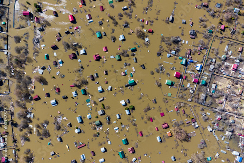 View from a high altitude of flooded houses in the countryside during the spring flood