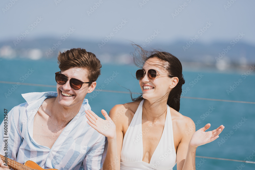 Caucasian couple who man and woman relax fun with luxury party drinking champagne by talking together while catamaran yacht boat sailing. Happy and enjoy outdoor lifestyle on summer vacation travel Caucasian couple who man and woman relax fun with luxury party drinking champagne by talking together while catamaran yacht boat sailing. Happy and enjoy outdoor lifestyle on summer vacation travel