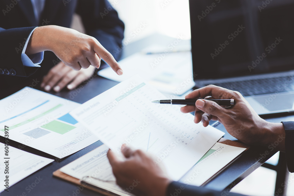 Close up view of business people discussing the charts and graphs showing the results of their successful teamwork. Close up view of business people discussing the charts and graphs showing the results of their successful teamwork.