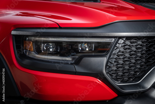 Red car headlights. Exterior detail. Close up detail on one of the LED headlights modern car.. © Виталий Сова