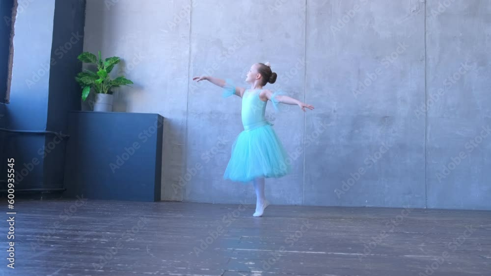A girl dancer in a ballet school is learning to dance. Little ballerina in training in a dance costume. Children's ballet school. 4K A girl dancer in a ballet school is learning to dance. Little ballerina in training in a dance costume. Children's ballet school. 4K