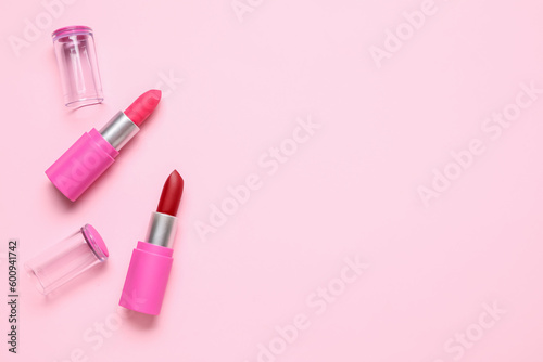 Different lipsticks on pink background