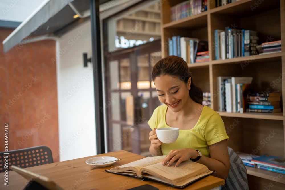 woman sitting at home reading a book and drinking coffee on vacation woman sitting at home reading a book and drinking coffee on vacation