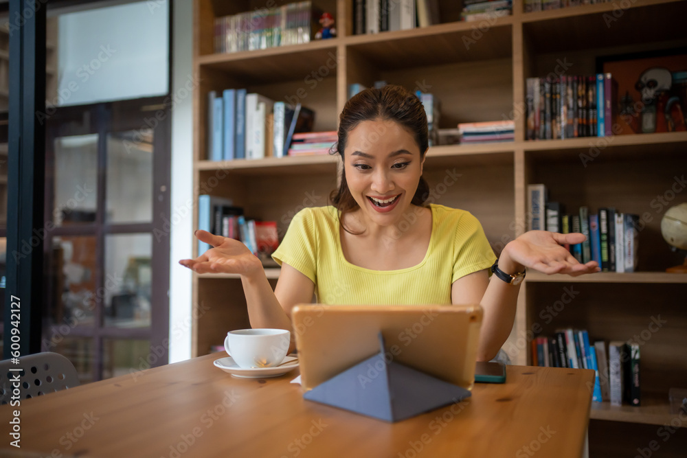 Female college student studying and working online with laptop and tablet at home Female college student studying and working online with laptop and tablet at home