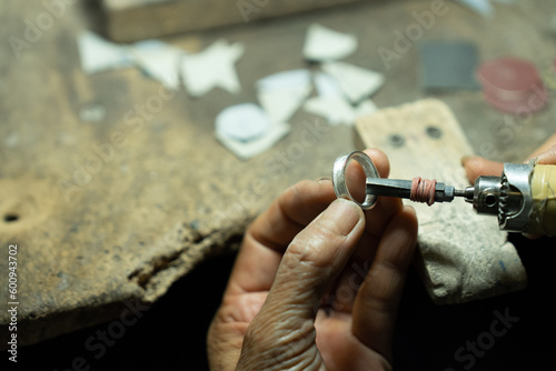 Close-up of craftsman hand making ring made of silver Folk handicrafts of Nan Province, Thailand