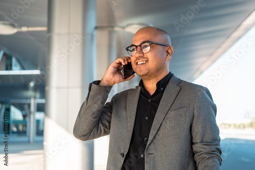 Senior manager business man in suit with cell phone at the buildings downtown. Confident man using smartphone looking towards their goals for success. Executive business man © Chanakon