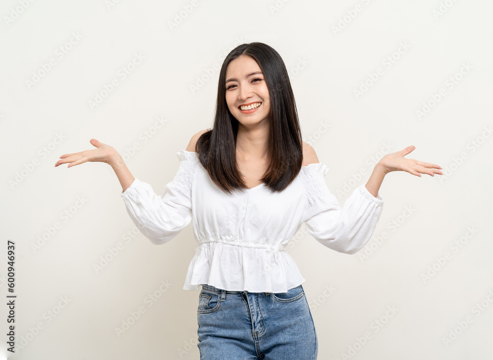 Beautiful smiling happy young asian woman in white shirt. Charming female lady open hands palm up holding something on isolated white background. Asian cute Pretty people looking copy space. Beautiful smiling happy young asian woman in white shirt. Charming female lady open hands palm up holding something on isolated white background. Asian cute Pretty people looking copy space.