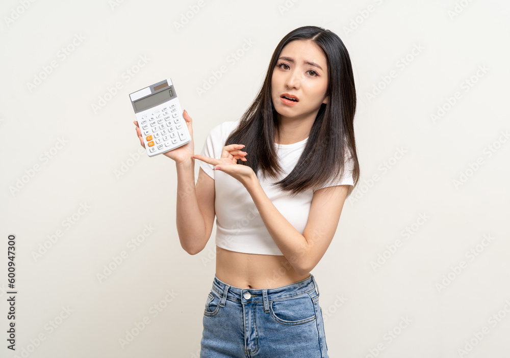 Upset confused bad emotional asian woman holding calculator. Unhappy stressed female have financial problems. Upset confused bad emotional asian woman holding calculator. Unhappy stressed female have financial problems.