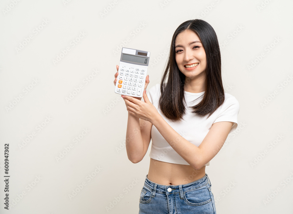 Beautiful smiling happy young asian woman holding calculator. Charming female lady standing pose financial concept. Beautiful smiling happy young asian woman holding calculator. Charming female lady standing pose financial concept.