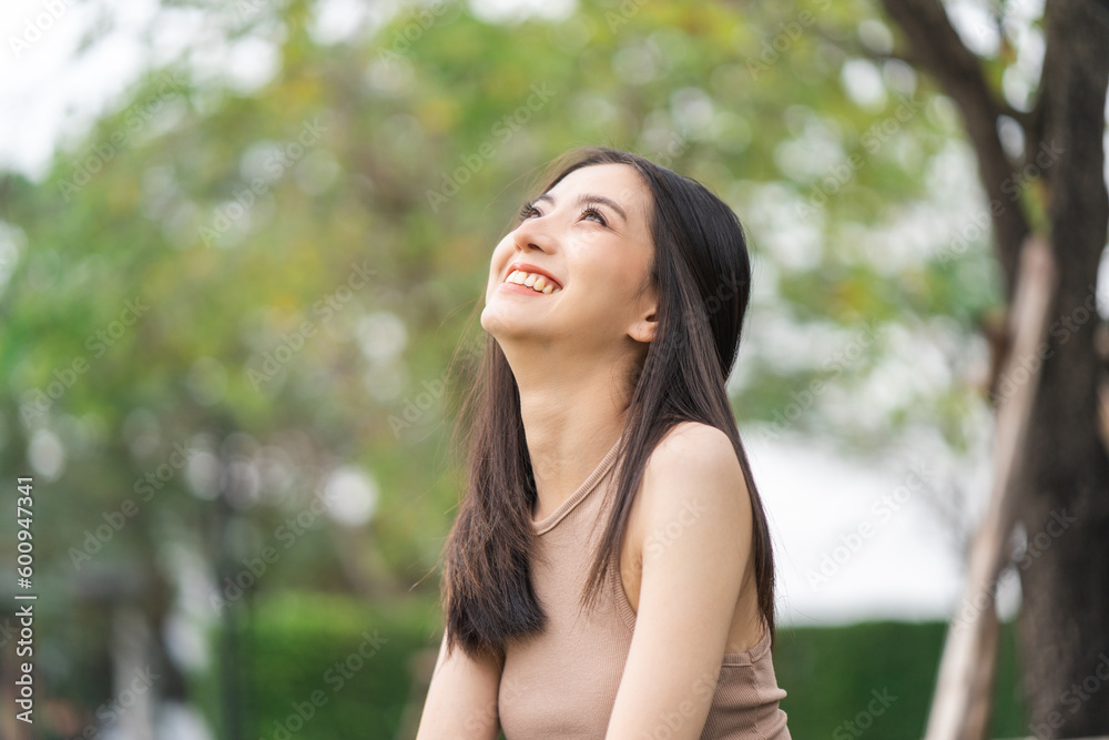 Happy feeling of Beautiful Young Woman smiling outdoor in sunlight. Pretty attractive face of female and beautiful smile. She is positive thinking and successful. Happy feeling of Beautiful Young Woman smiling outdoor in sunlight. Pretty attractive face of female and beautiful smile. She is positive thinking and successful.