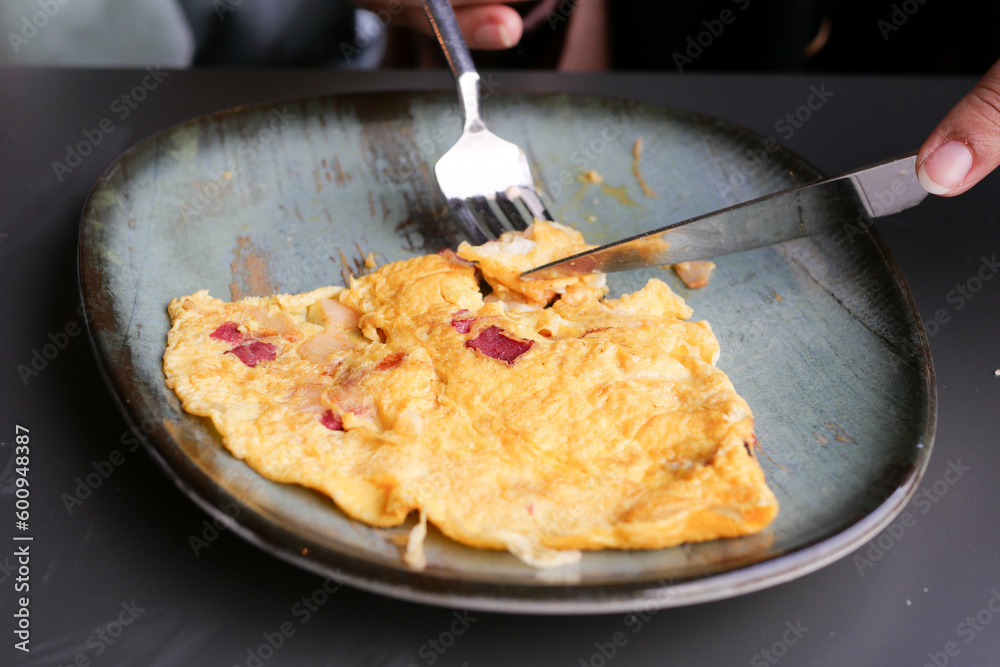 eating Plain Egg Omelette on table 