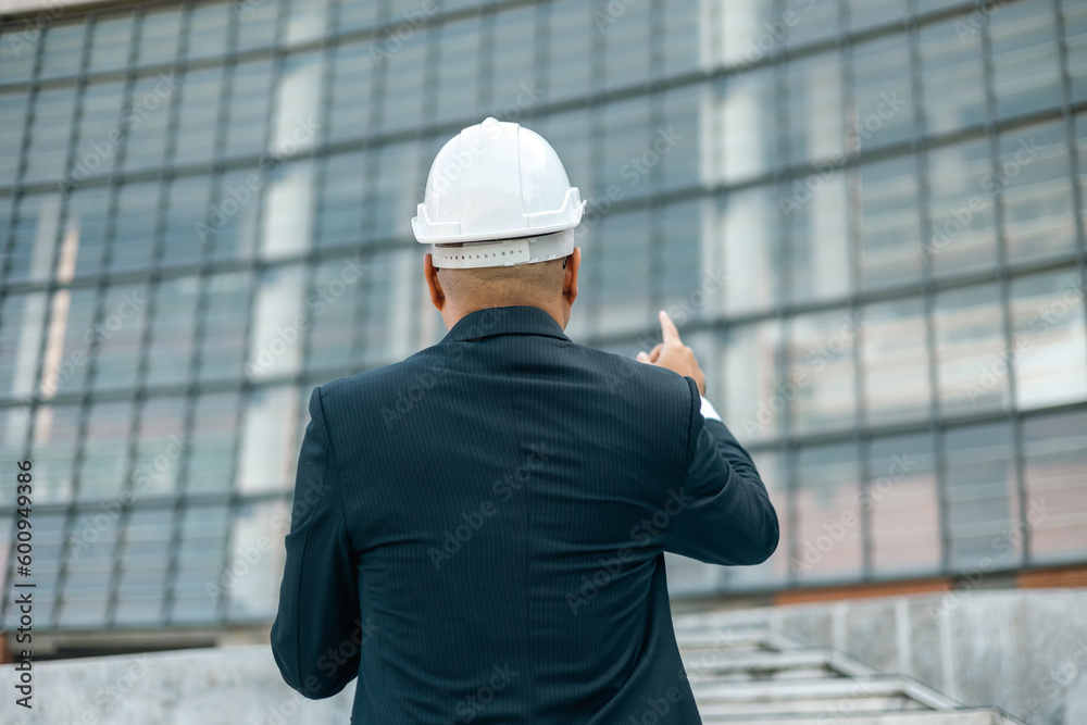 Businessman manager owner real estate working with digital tablet at modern office building. Cooperation of architect designer. Engineer with safety helmet checking at working construction site Businessman manager owner real estate working with digital tablet at modern office building. Cooperation of architect designer. Engineer with safety helmet checking at working construction site