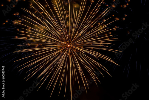 Bright rays of fire on black background. Festive fireworks against of night sky in honor of Victory Day.