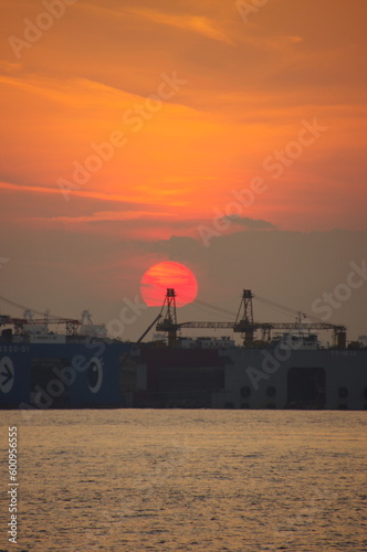 港に沈むオレンジ色の夕日 © Giusto