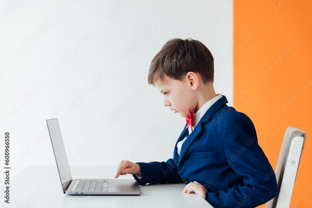 education IT knowledge child sitting at a laptop at school education IT knowledge child sitting at a laptop at school