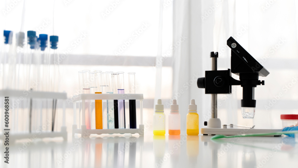 microscope and test tubes in a chemical laboratory microscope and test tubes in a chemical laboratory